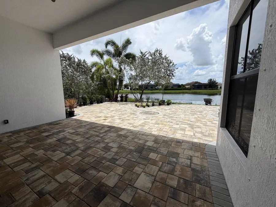 Lakefront paver patio in Ave Maria, FL by Creative Grounds