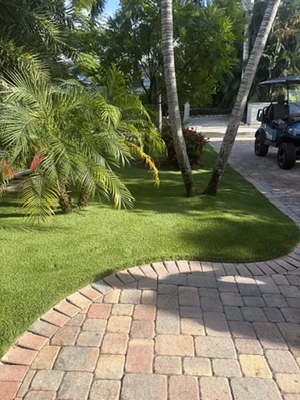 Curved artificial turf edge with paver border on Captiva Island