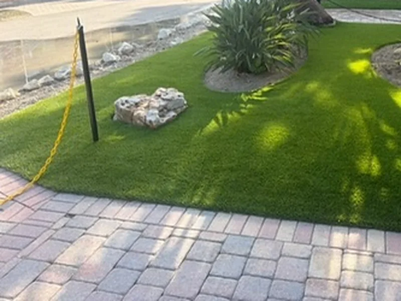 Captiva Island entry with artificial turf, boulder and paver border after installation