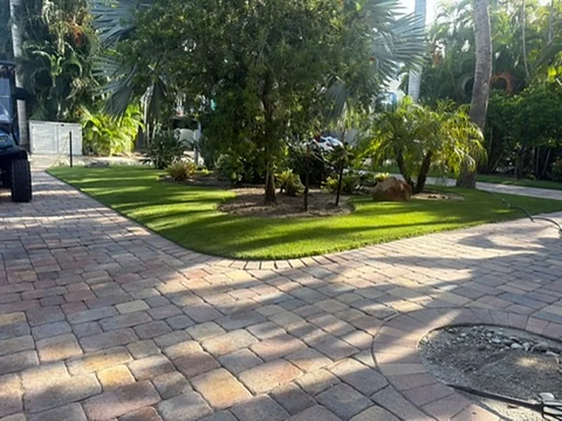 Captiva Island artificial grass lawn framed by a paver driveway