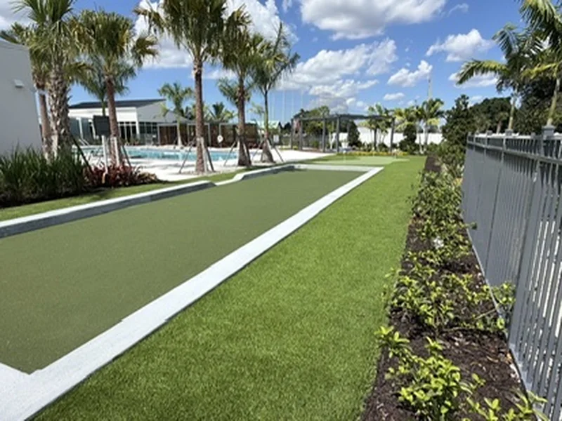 Commercial community bocce court with turf surround next to the pool in Naples, FL