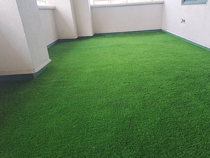 Condo balcony artificial turf cut clean around columns and railing