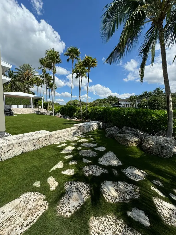 Coral stone stepping stones in turf by Creative Grounds