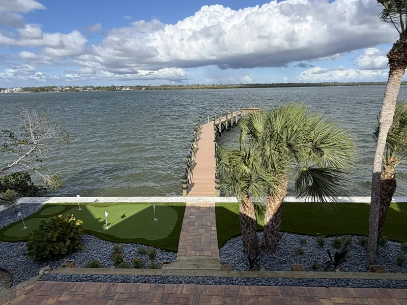 Waterfront artificial grass lawn with putting green and dock in Englewood, FL