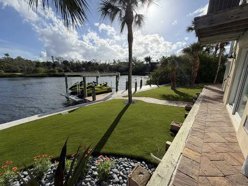 Waterfront artificial turf lawn beside a jet ski dock in Englewood