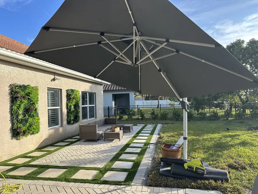 Herringbone patio with turf steppers in Fort Myers, FL by Creative Grounds