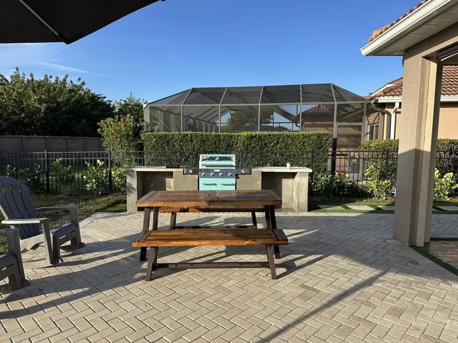 Paver patio with outdoor kitchen in Fort Myers, FL by Creative Grounds