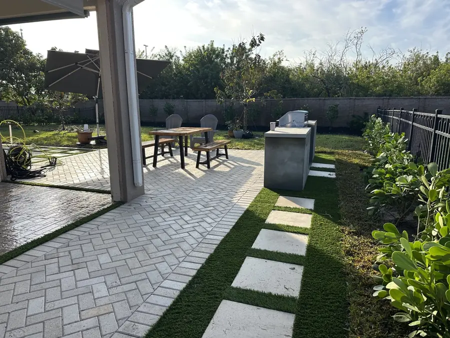 Paver walkway and turf stepping stones in Fort Myers, FL by Creative Grounds