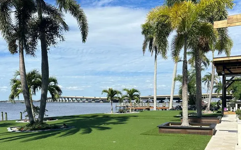 Riverfront artificial grass lawn with palms in Fort Myers