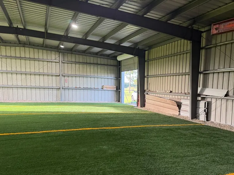 Clean gravel perimeter along indoor training turf