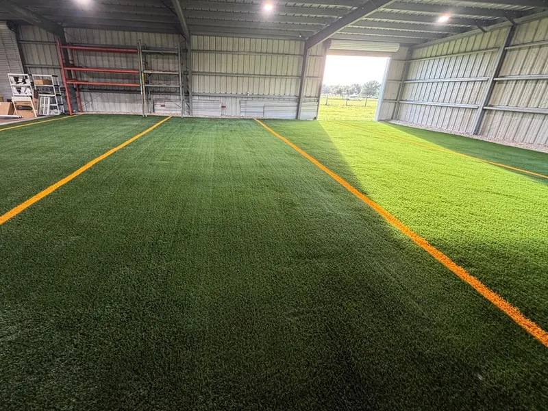 Inlaid orange lines on indoor sports turf