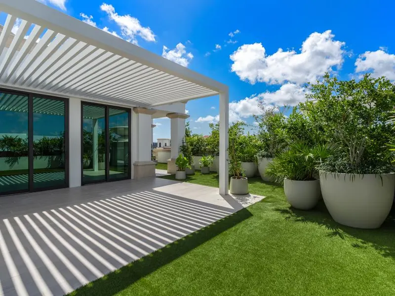 Luxury penthouse rooftop terrace with artificial turf and pergola in Coral Gables, FL