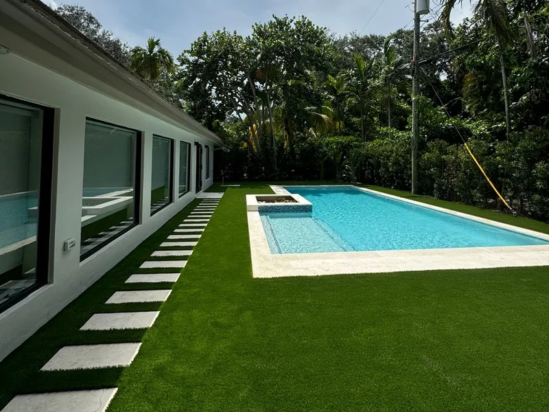 Modern home with artificial turf lawn, stepping pad path and pool