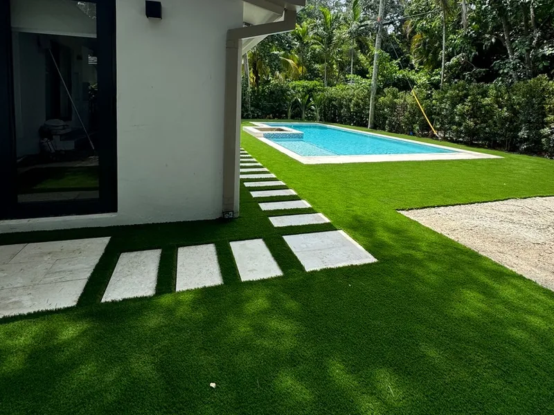 Stepping pads in artificial turf leading from the door to the pool