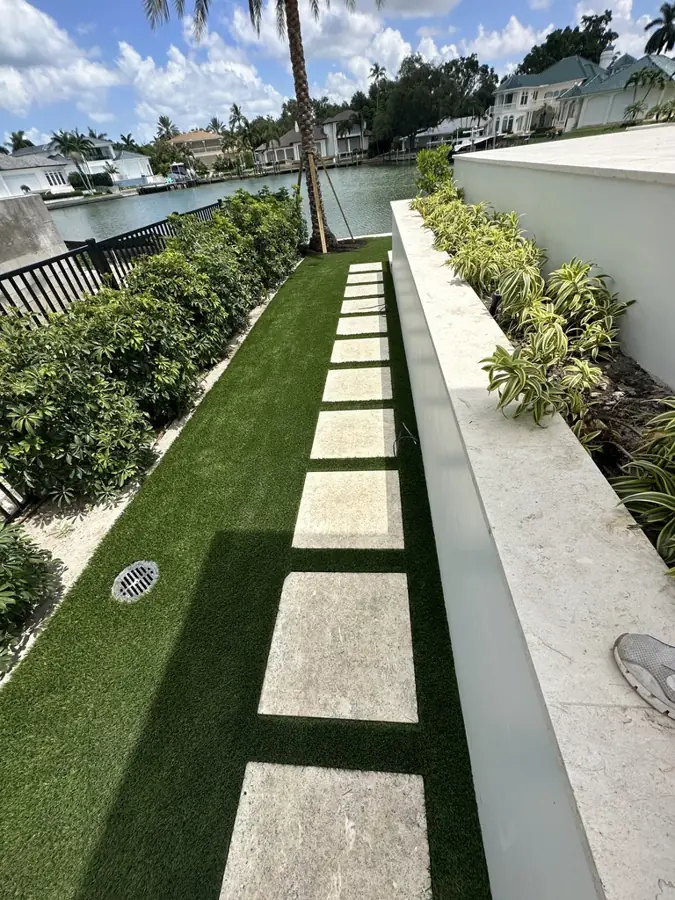 Canal-side stepping pads in turf in Naples, FL by Creative Grounds