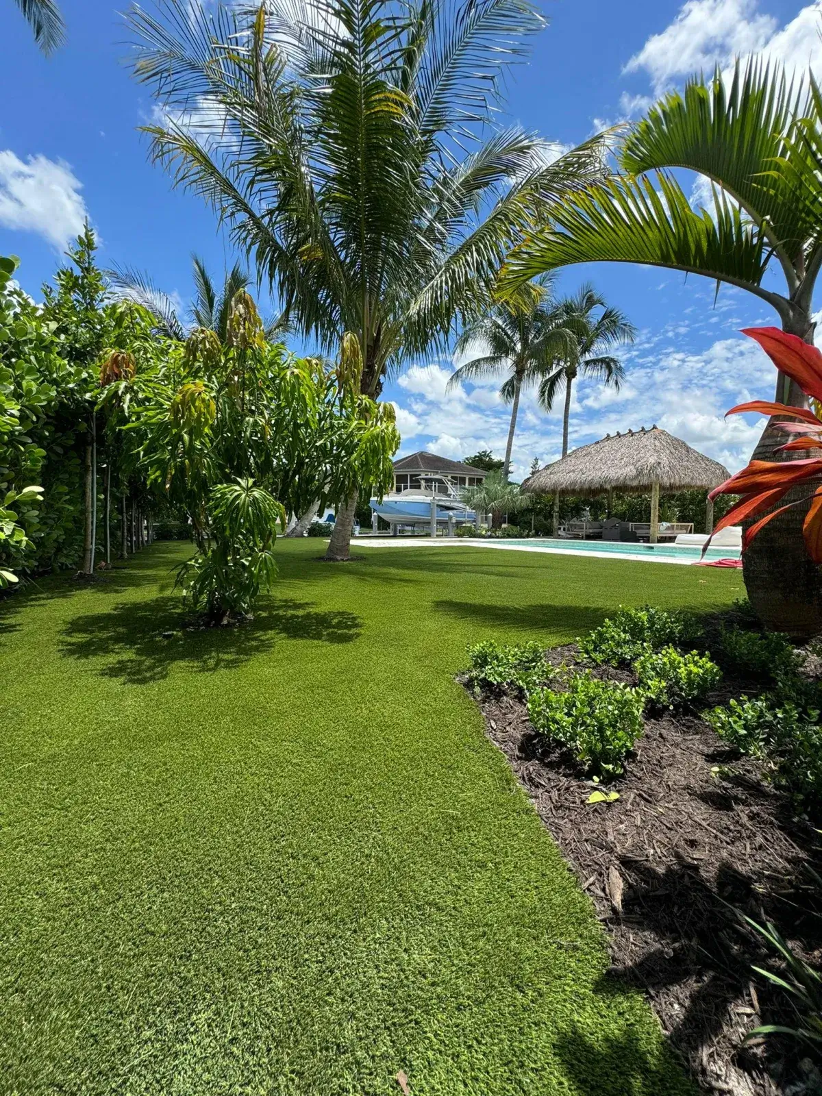Lush artificial grass lawn with tropical landscaping in Naples