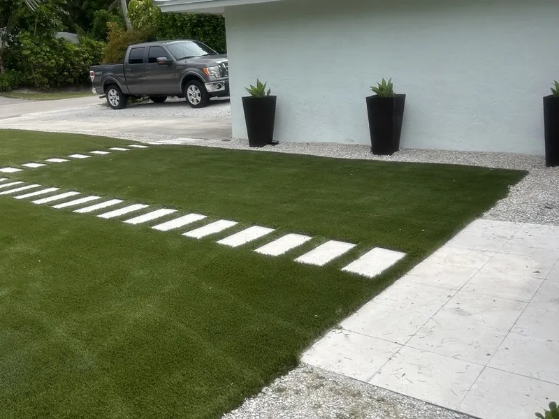 Turf and stepping pads meeting a stone driveway in Naples
