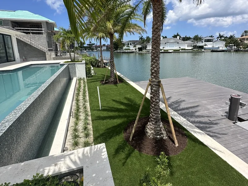 Artificial grass lawn with palms on the bay in Naples