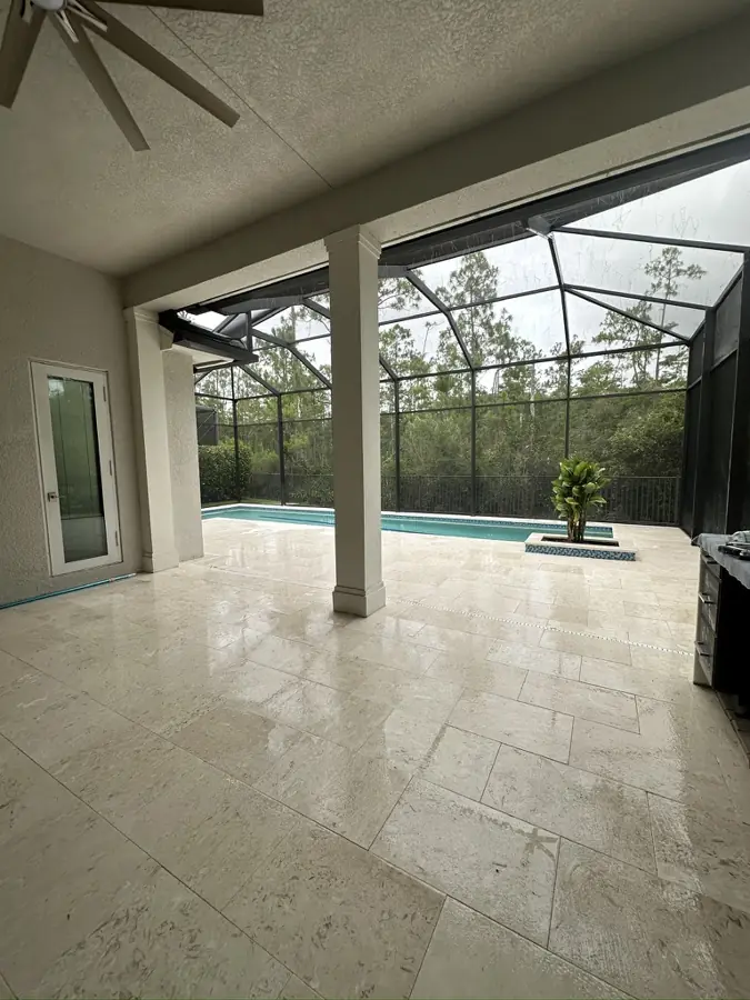 Travertine lanai in North Naples, FL by Creative Grounds