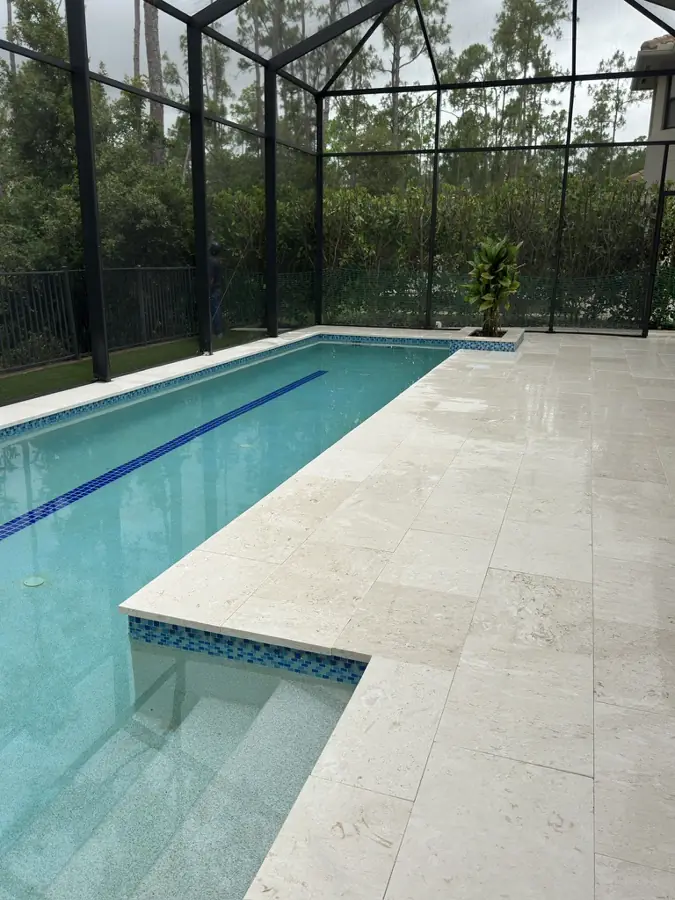 Travertine pool deck and coping in North Naples, FL by Creative Grounds