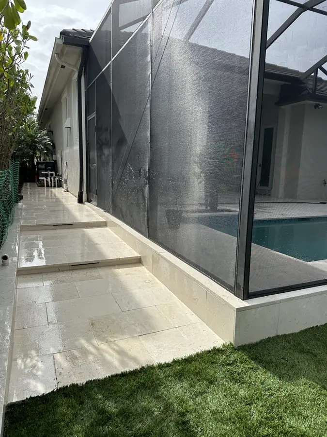 Travertine walkway and cage curb in North Naples, FL by Creative Grounds