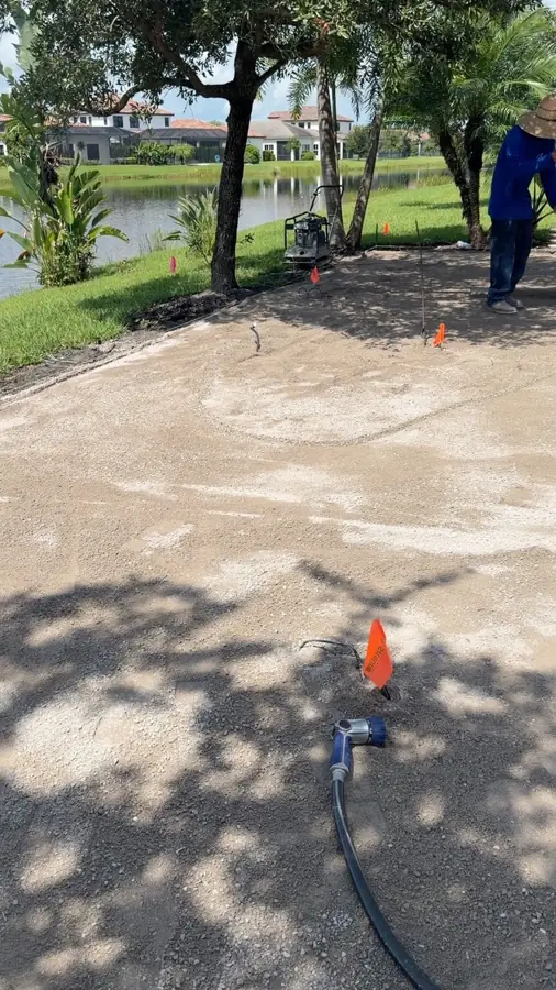 Compacting the base before pavers in Ave Maria, FL by Creative Grounds