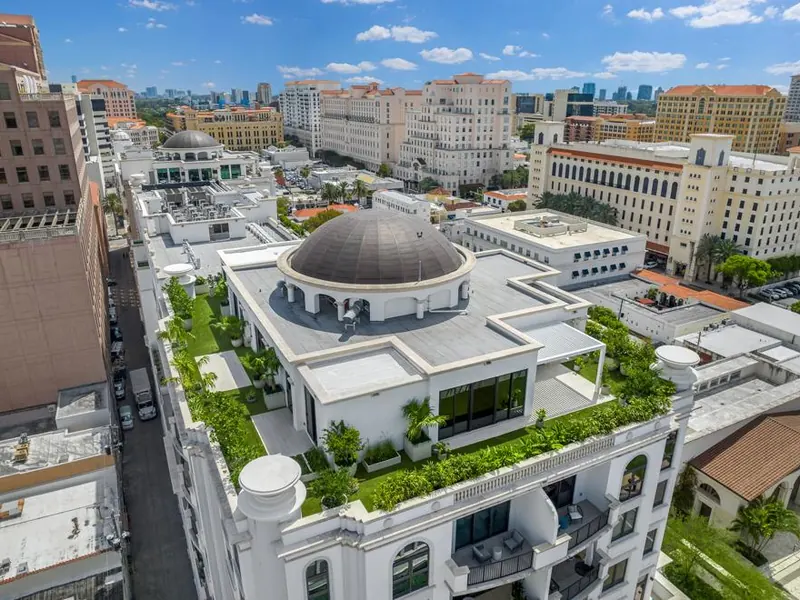 Aerial view of a Coral Gables penthouse rooftop with wraparound artificial turf terraces