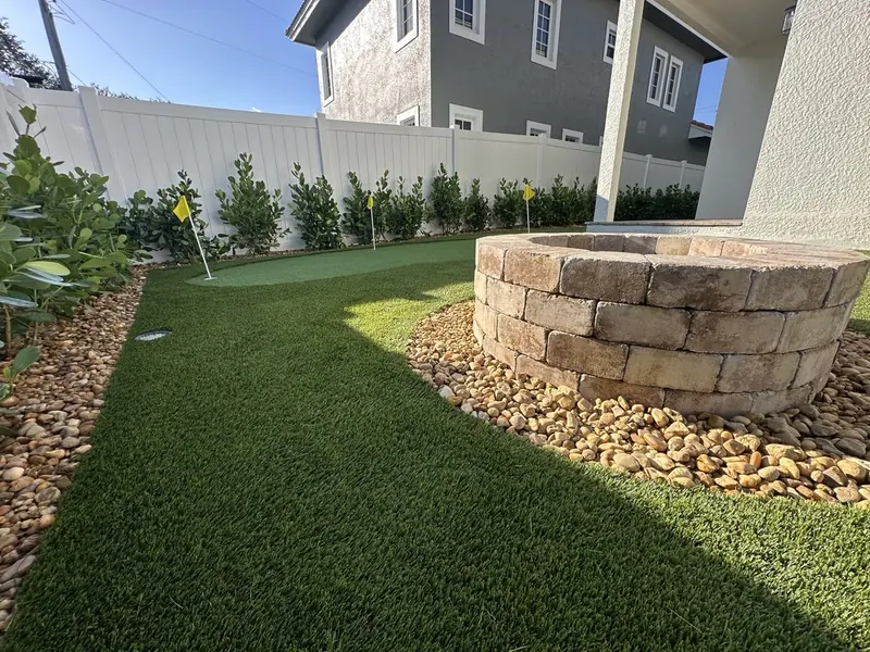 Paver fire pit with river rock by Creative Grounds at the Pink House in Bonita Springs FL