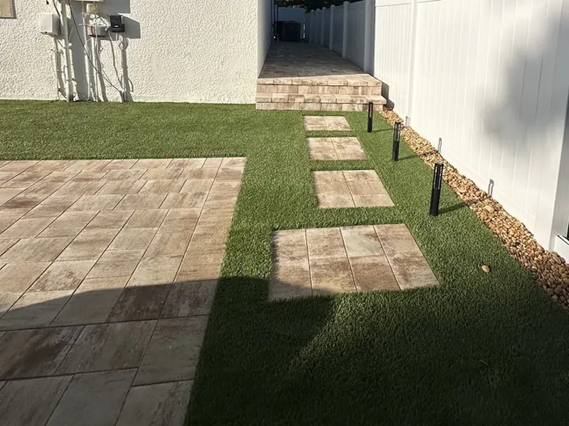 Stepping stones to the side walkway by Creative Grounds at the Pink House in Bonita Springs FL