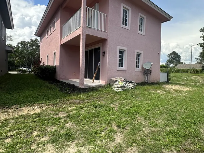 Before: patchy backyard at the Pink House in Bonita Springs FL