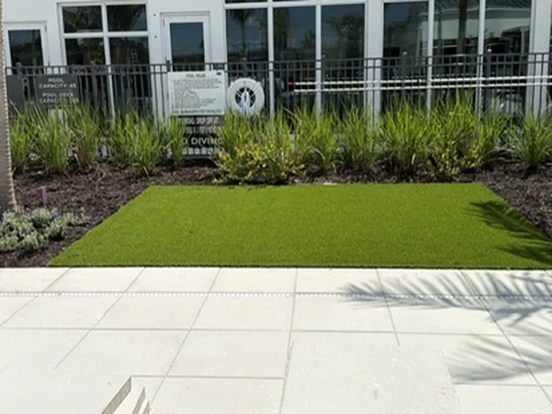 Artificial turf accent on a community pool deck