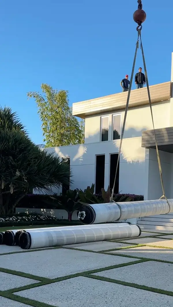 Turf rolls lifted by crane in Naples, FL by Creative Grounds