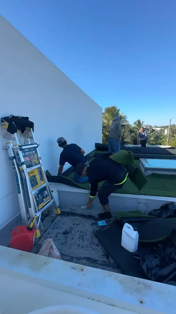 Crew installing rooftop turf in Naples, FL by Creative Grounds