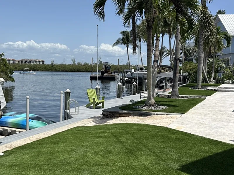 Waterfront artificial grass lawn with dock and palms in Sarasota