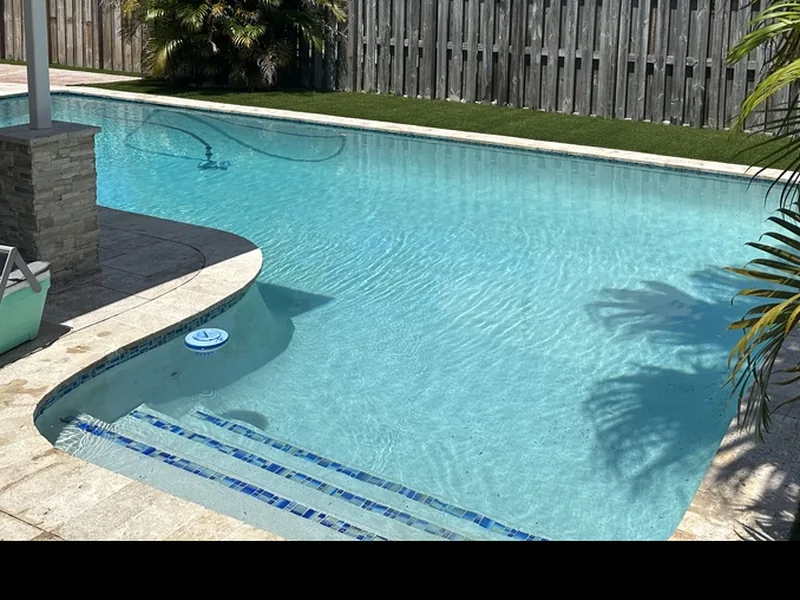 Screened pool area during installation with graded base, drain and stepping pads