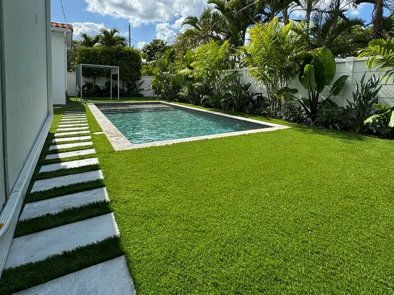 Side yard stepping pad path in artificial turf to a pool