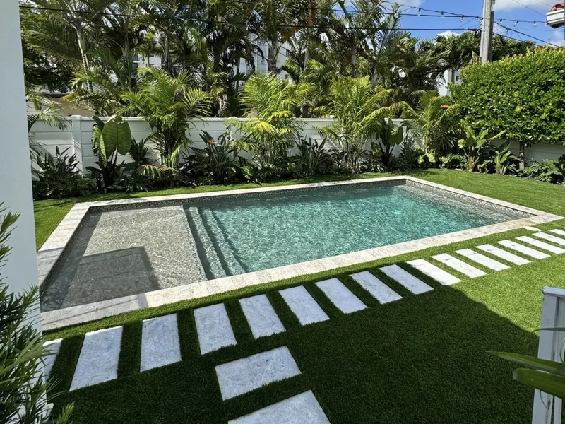 Pool courtyard with artificial turf and marble stepping pads